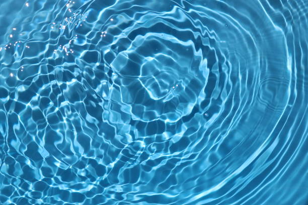 istock Blue and bright water surface with sun refection in swimming pool for background 1156877507