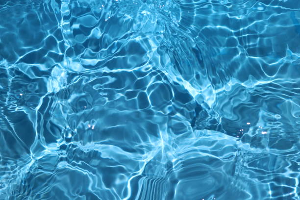 istock Blue and bright water surface with sun refection in swimming pool for background 1156877704