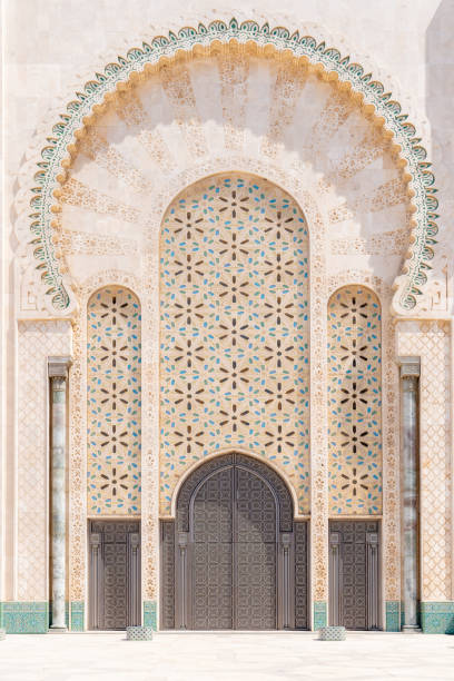 Main entrance doors of the Hassan II Mosque in Casablanca Massive entrance doors of Hassan II Mosque, decorated with traditional Moroccan patterns and an arch. casablanca stock pictures, royalty-free photos & images
