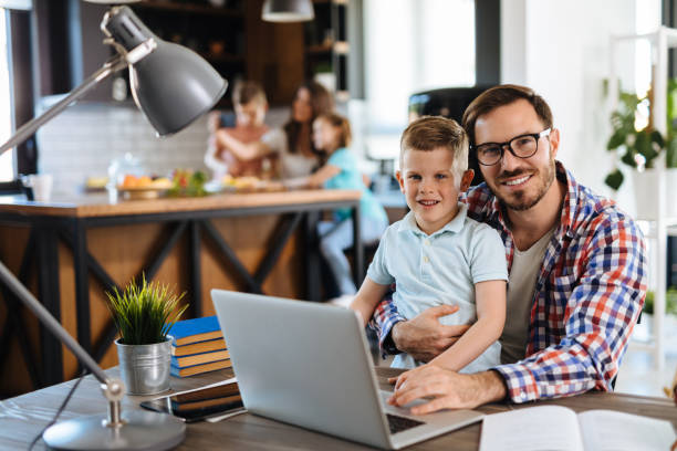 istock Father and son using laptop at home 1156884256