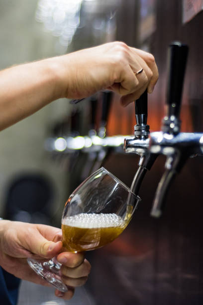 istock bartender hand at beer tap pouring a draught beer in glass serving in a restaurant or pub 1156884480