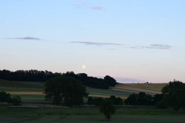istock dusk clouds over green hills 1156884576
