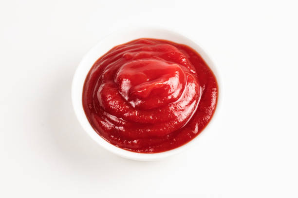 istock Ketchup in white plate on white background. 1156884671