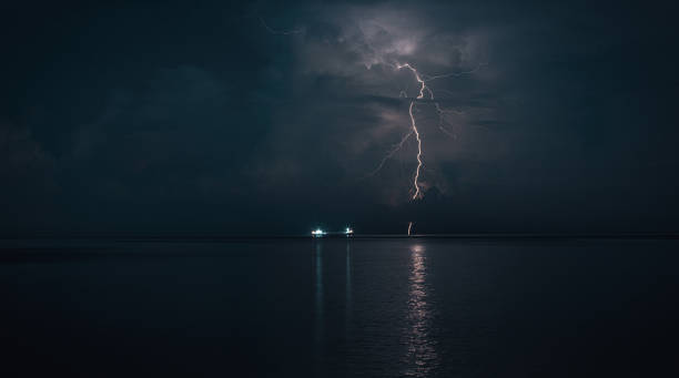 istock Stunning view of lightning storm with sea ship 1156885619