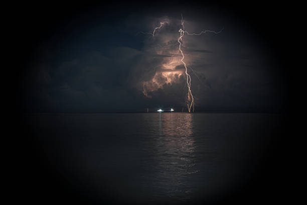istock Long exposure view of lightning storm with sea ship 1156885800