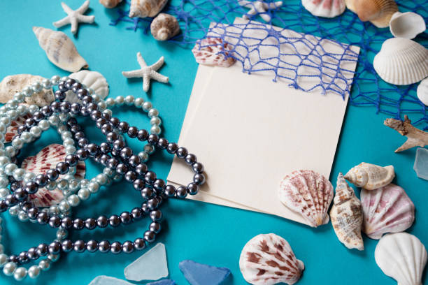istock Summer theme.Blank white sheet and various marine elements for decoration and pearls. Letter of Summer 1156887094