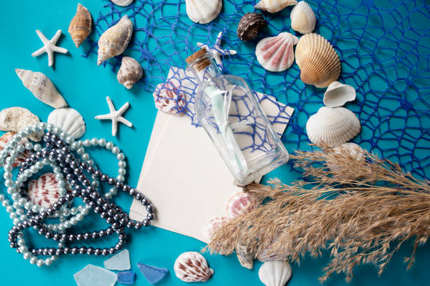 istock Summer theme.Blank white sheet and various marine elements for decoration and pearls. Letter of Summer 1156887141