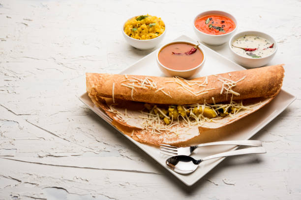 istock cheese masala dosa recipe with sambar and chutney, selective focus 1156887612