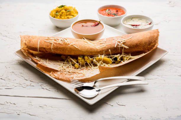 istock cheese masala dosa recipe with sambar and chutney, selective focus 1156887649