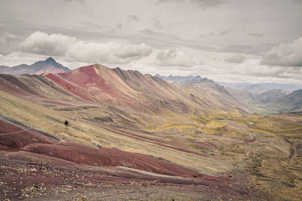 istock Rainbow mountain or Vinicunca in southern Peru. Lonely man doing trekking 1156887758