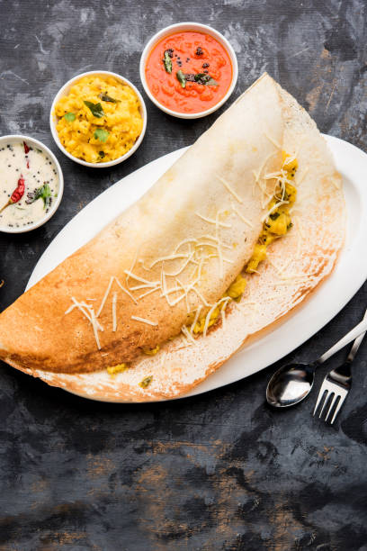 istock cheese masala dosa recipe with sambar and chutney, selective focus 1156887951