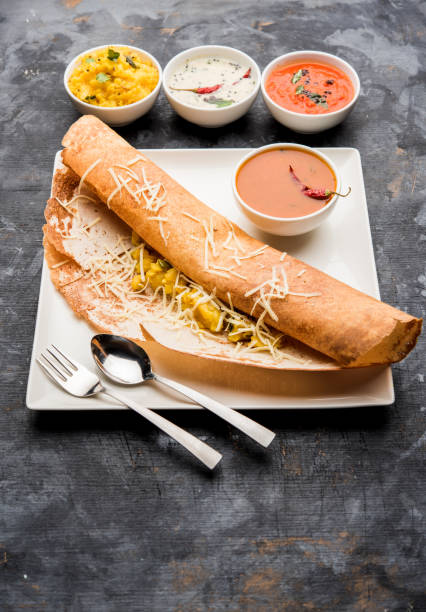 istock cheese masala dosa recipe with sambar and chutney, selective focus 1156888626
