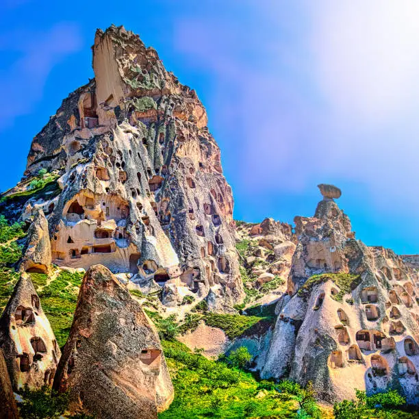 Lying in south central Turkey, the moonscaped region of Cappadocia, southeast of Ankara, is most famous for unique geological features called fairy chimneys, cave houses and churches .