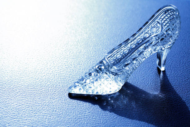 Glass Slipper On Blue One nice glass slipper on blue background with shadow pics of the godmother stock pictures, royalty-free photos & images