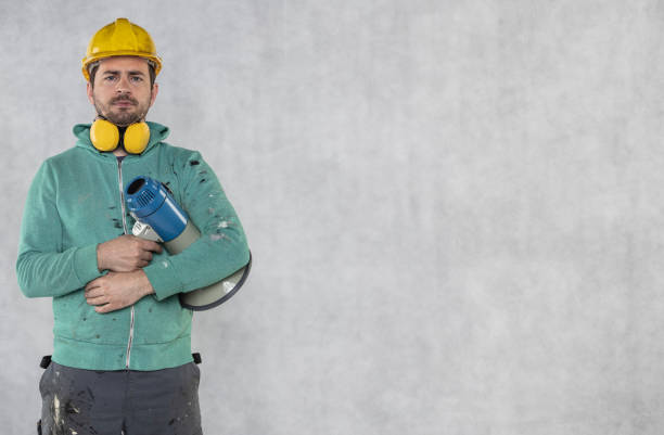 istock the construction worker holds a megaphone in his hands, the concept of issuing orders 1156891300
