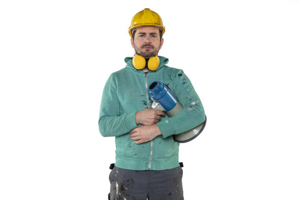 the construction worker holds a megaphone in his hands, the concept of issuing orders