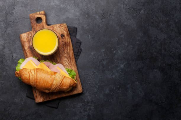 istock Orange juice and croissant sandwich 1156891513
