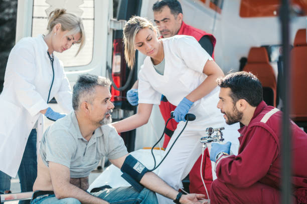 istock Doctor and paramedics helping mature man 1156892363