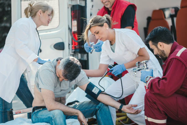istock Doctor and paramedics helping mature man 1156892830
