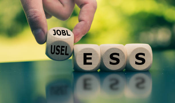 istock Being jobless and feeling useless. Hand turns a cube and changes the word 