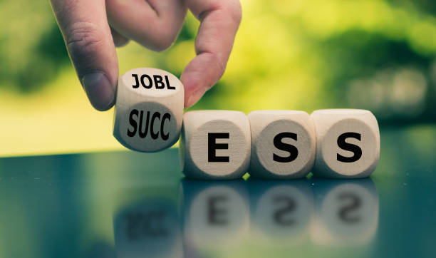 concept of a turning point in life. hand turns a cube and changes the word "jobless" to "success". - turning point imagens e fotografias de stock