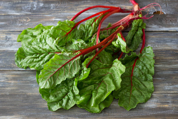 istock Fresh raw leaves of chard, leaf beets, mangold on a wooden table 1156894230