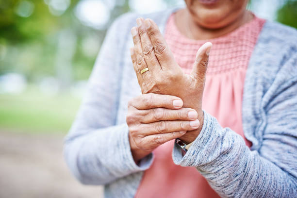 I've got arthritis in my hand Cropped shot of an unrecognizable senior woman suffering from arthritis in her hand while in the park alone arthritis stock pictures, royalty-free photos & images
