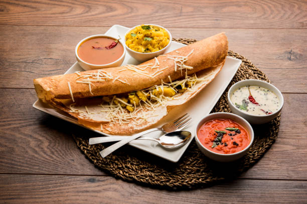 cheese masala dosa recipe with sambar and chutney, selective focus