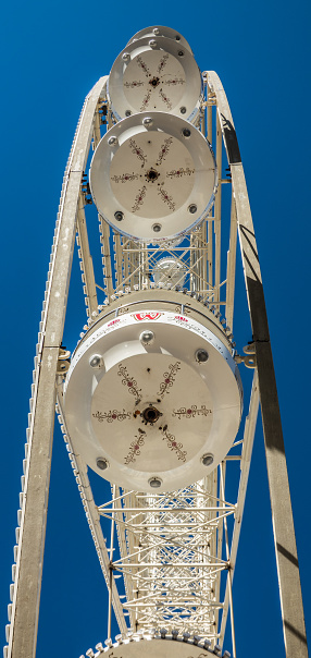 Honnover, Lower Saxony, Germany, October 13., 2018: Close-up view of the white cabin of a Ferris wheel from below