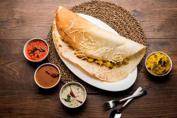 istock cheese masala dosa recipe with sambar and chutney, selective focus 1156896900