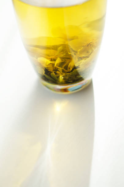 istock Brewed delicious herbal tea on a wooden white background, shadow and sun rays. - Image 1156898287