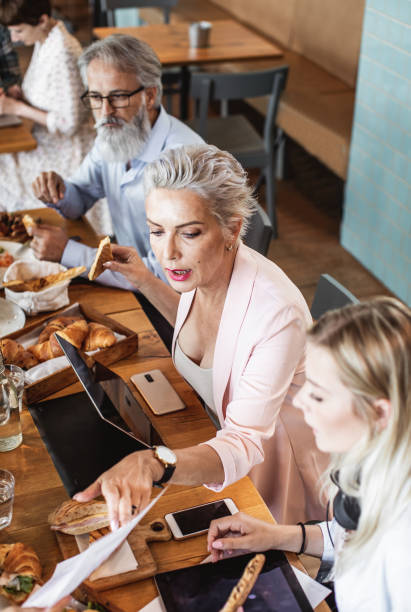 istock Small Group of Business People on a Lunch Break 1156899302
