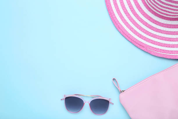 istock Beach hat with bag and sunglasses on blue background 1156900280