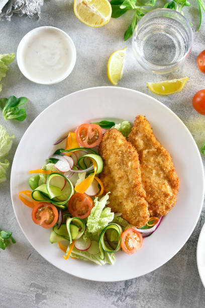 istock Fresh vegetable salad and breaded chicken breast 1156900525