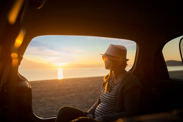 istock Watching the sunset on the beach 1156901431