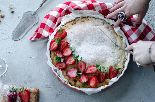 istock woman's hand is cutting pies 1156901519