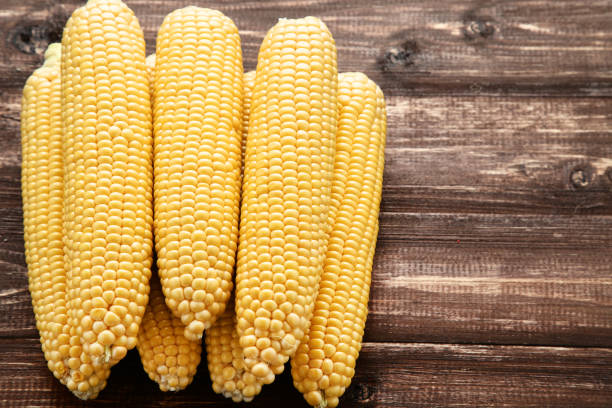 istock Ripe corn on brown wooden table 1156901545