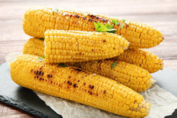 istock Grilled corn with green parsley on wooden table 1156901576