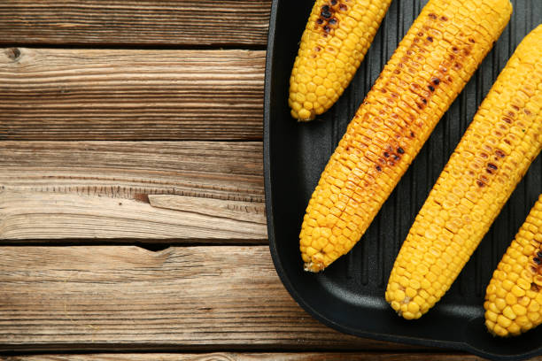 istock Grilled corn in pan on brown wooden table 1156901610