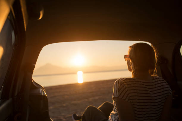istock Watching the sunset on the beach 1156902042