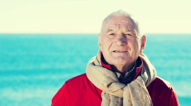 istock Mature man walking by sea 1156903062