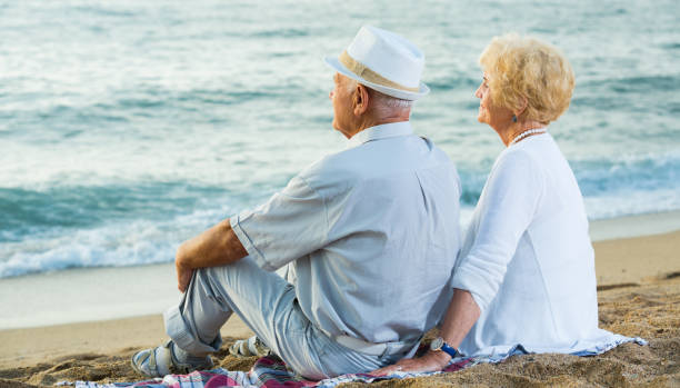 istock pensioners sitting back together at the sea 1156903244