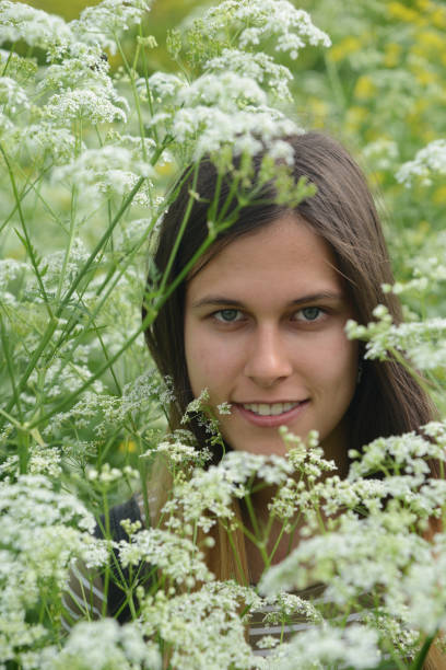 istock Girl among white flowers 1156904537