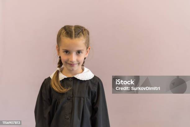 Elementary School Student Posing In Uniform Stock Photo - Download Image Now - 6-7 Years, Apron, Cheerful