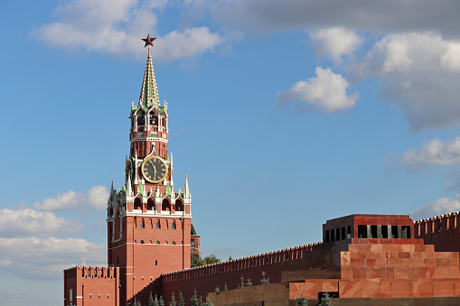 Spasskaya tower against the blue sky with clouds, russian landmarks