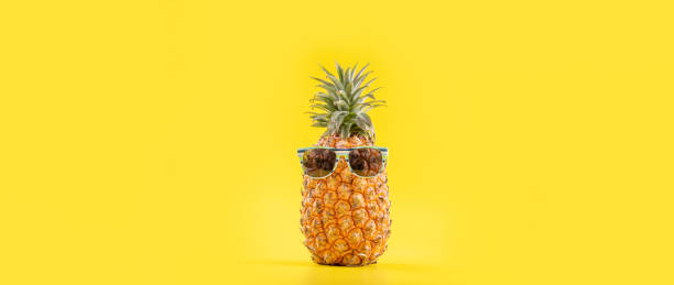 istock Creative pineapples with sunglasses isolated on yellow background, summer vacation beach idea design pattern, copy space, close up, blank for text 1156911129