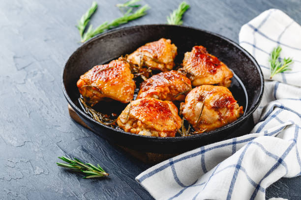 istock Delicious fried chicken thighs in a cast iron skillet 1156911185