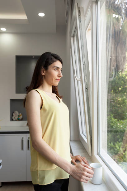 istock Business woman looking at window 1156915755