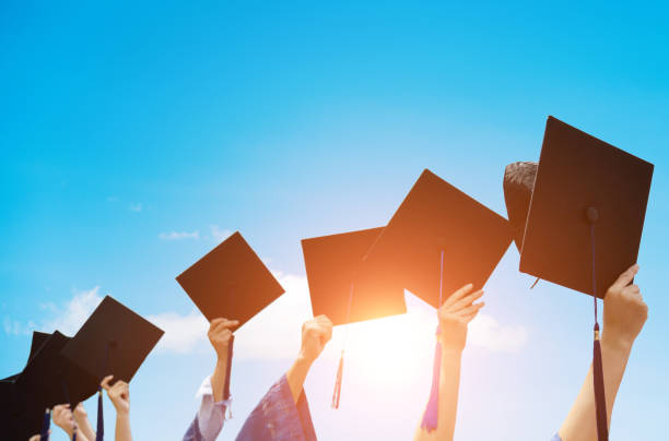 istock Group of graduate students holding their graduation hats 1156916704