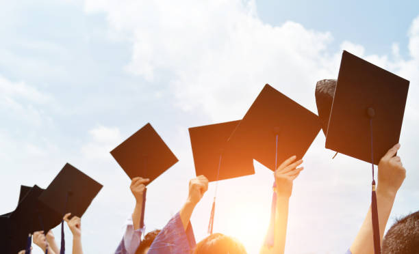 istock Group of graduate students holding their graduation hats 1156916705